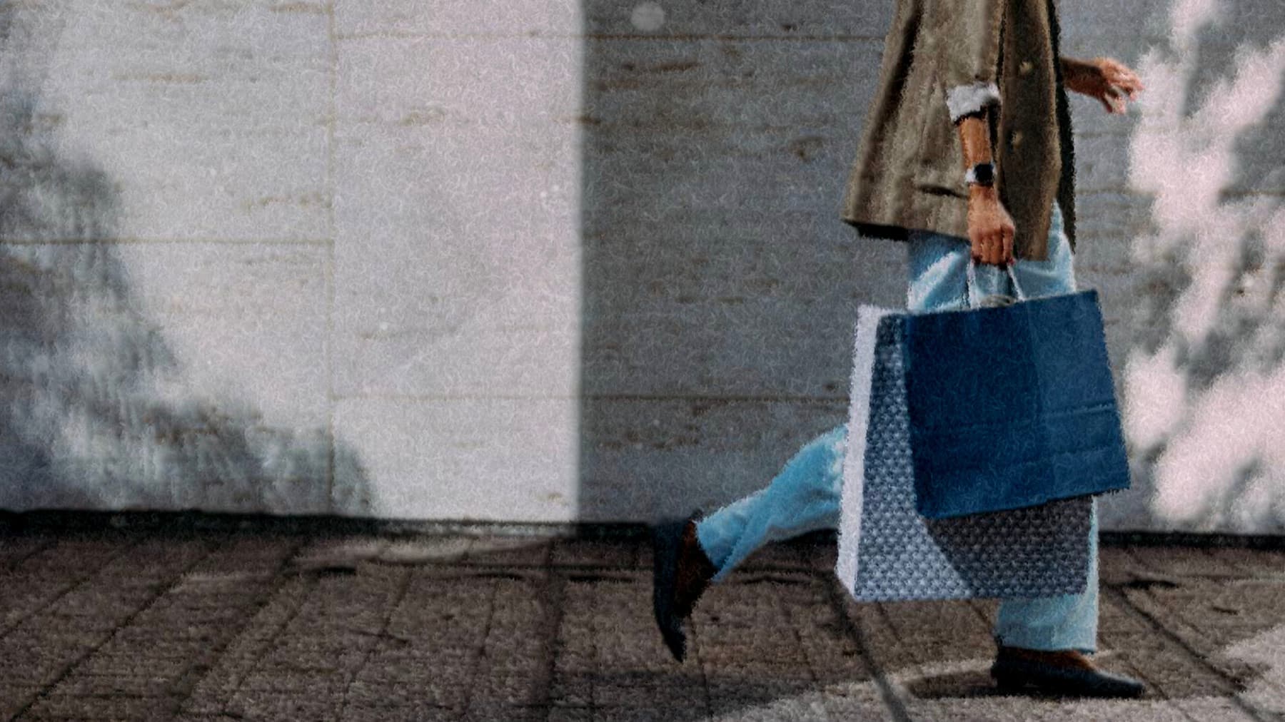 A shopper mid-stride carrying two shopping bags, rendered in Kinect's painterly texture